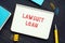 Financial concept about LAWSUIT LOAN with phrase on the sheet. AÂ lawsuit loanÂ is aÂ cash advanceÂ against a futureÂ lawsuitÂ 